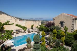 Outdoor view of garden & pool from Ontas Classic Suite